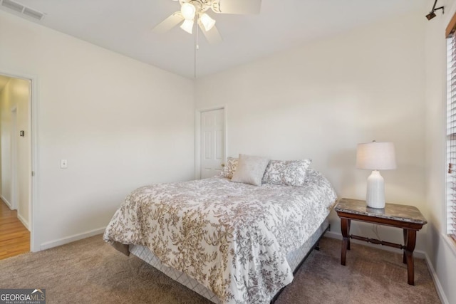 bedroom featuring ceiling fan and carpet