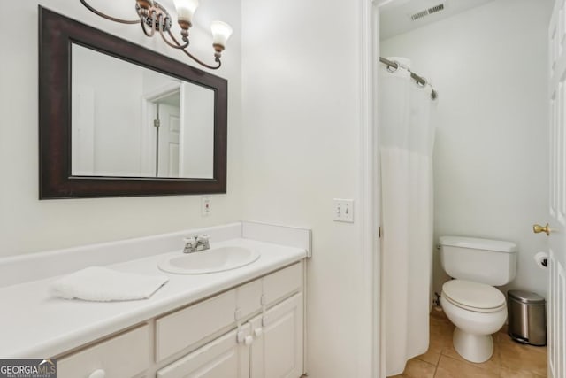 bathroom with toilet, a shower with curtain, vanity, and tile patterned floors