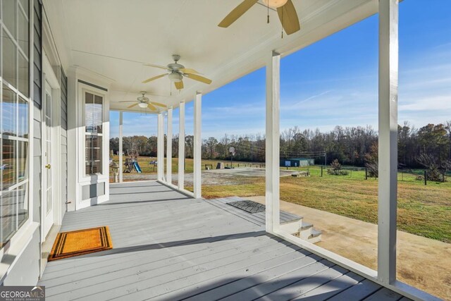 back of house with covered porch and a yard