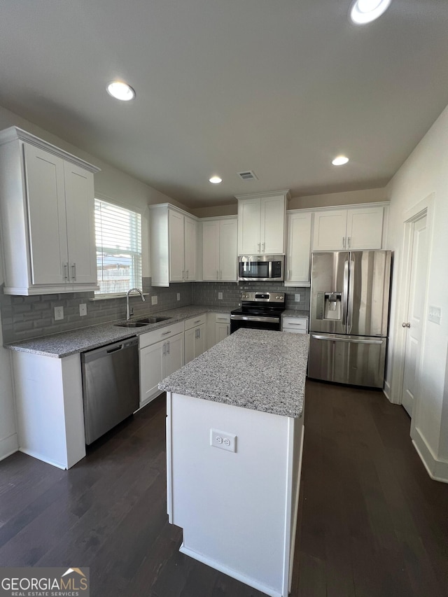 kitchen featuring white cabinetry, sink, dark wood-type flooring, and appliances with stainless steel finishes