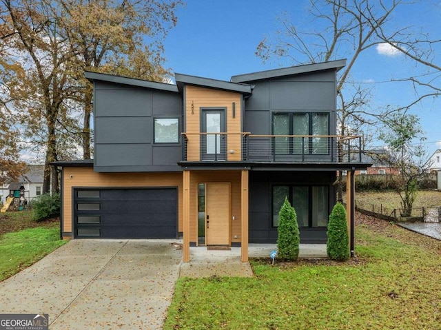 contemporary house with a garage and a front yard