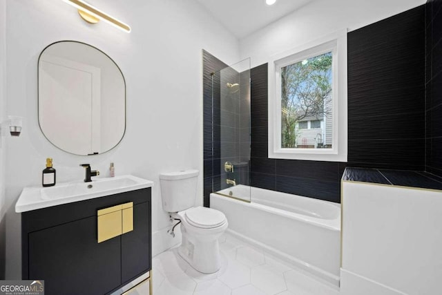 full bathroom with tiled shower / bath, vanity, toilet, and tile patterned flooring