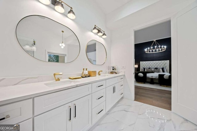 bathroom with vanity and a notable chandelier