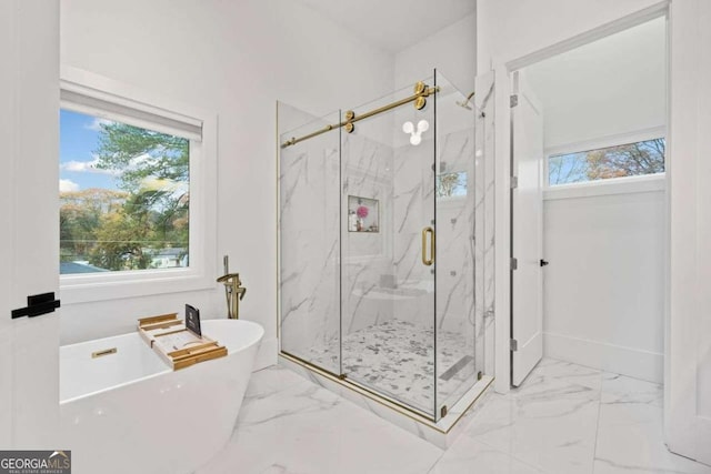 bathroom featuring a healthy amount of sunlight and shower with separate bathtub