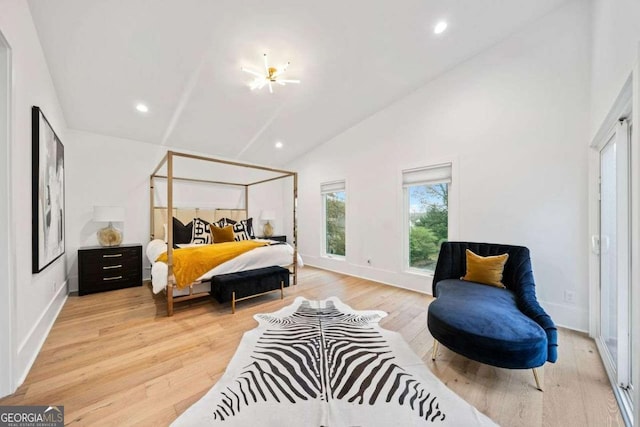 bedroom featuring vaulted ceiling and light hardwood / wood-style floors