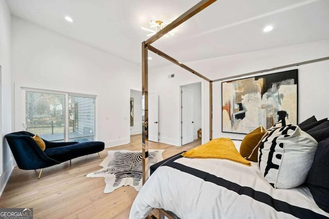 bedroom featuring lofted ceiling and light hardwood / wood-style floors