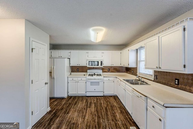 kitchen featuring sink, tasteful backsplash, dark hardwood / wood-style flooring, white appliances, and white cabinets