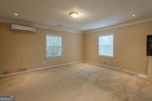 unfurnished room featuring light carpet, a wall unit AC, and a wealth of natural light