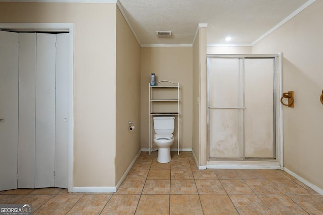 bathroom with tile patterned flooring, toilet, and crown molding