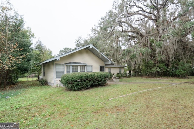 view of home's exterior with a lawn