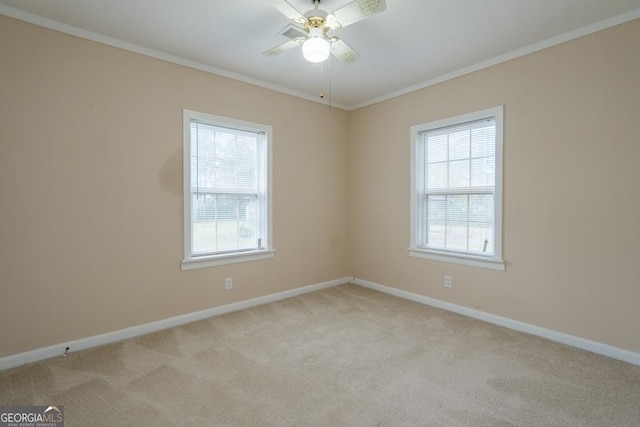 spare room with light carpet, ceiling fan, and ornamental molding