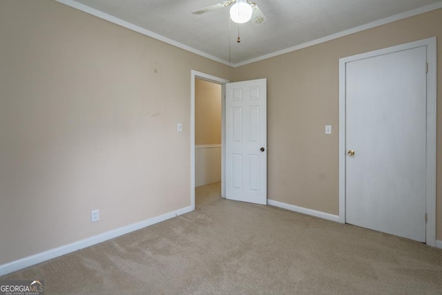 unfurnished bedroom featuring ceiling fan, light carpet, and ornamental molding