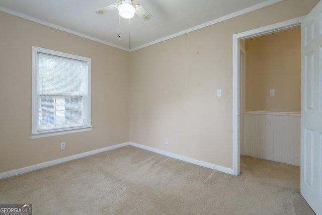 spare room featuring light colored carpet and ornamental molding