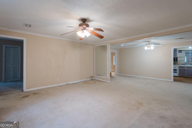 interior space with a textured ceiling, light colored carpet, and crown molding