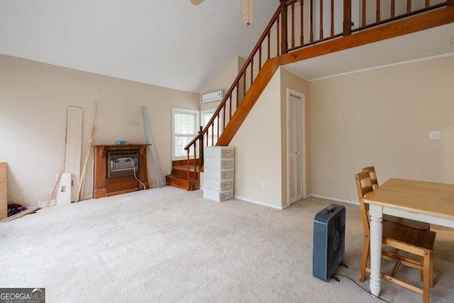 living room with carpet flooring, a towering ceiling, and a wall unit AC