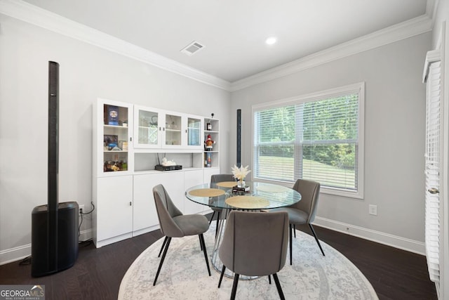 dining room with dark hardwood / wood-style flooring and ornamental molding