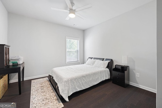 bedroom featuring ceiling fan and dark hardwood / wood-style floors