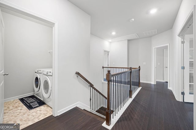 interior space featuring dark wood-type flooring and washing machine and clothes dryer