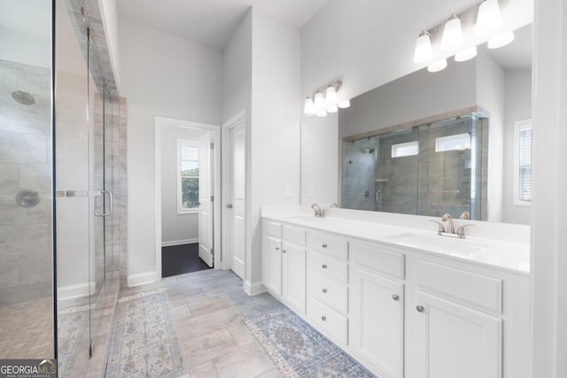 bathroom featuring vanity and an enclosed shower