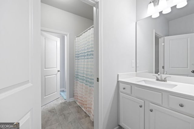 bathroom with curtained shower, tile patterned flooring, and vanity