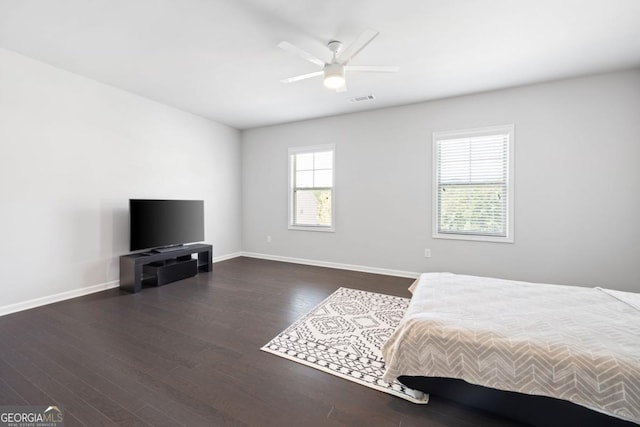 unfurnished bedroom featuring dark hardwood / wood-style floors and ceiling fan