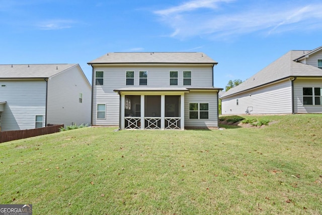 back of house featuring a sunroom and a yard