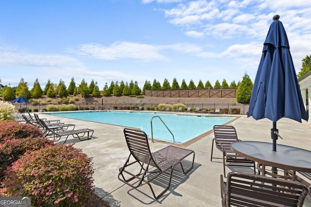 view of swimming pool featuring a patio area