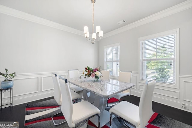 dining space with a notable chandelier and ornamental molding