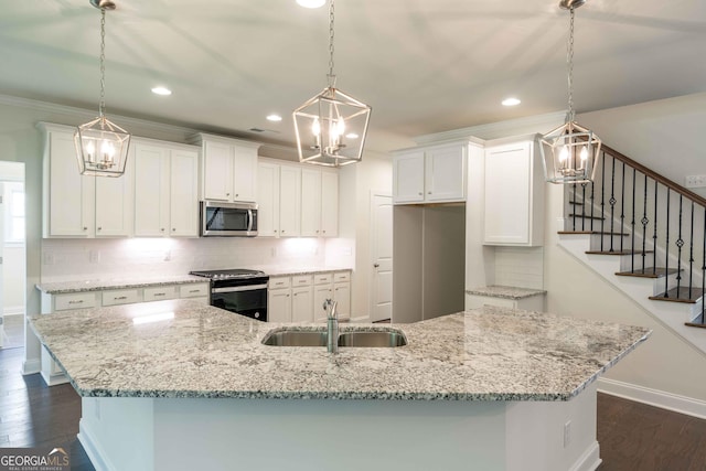 kitchen featuring white cabinets, decorative light fixtures, and black / electric stove