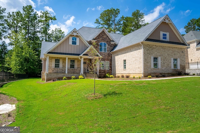 craftsman-style house with a front yard and a porch