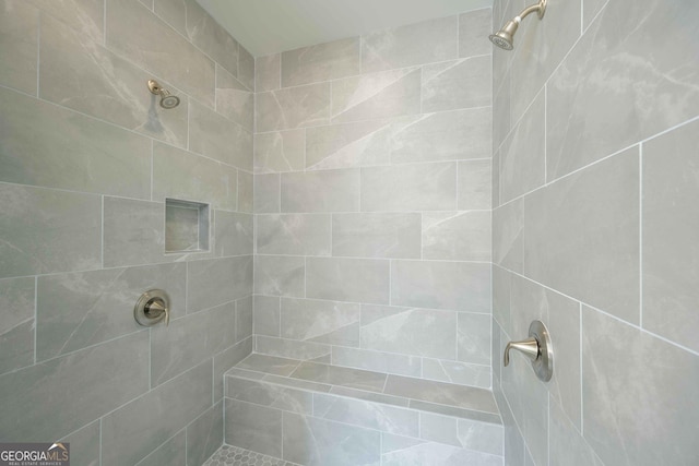 bathroom with a tile shower