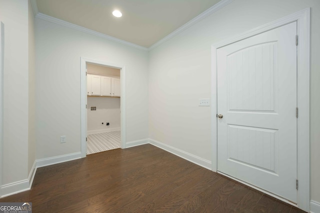 spare room featuring ornamental molding and dark wood-type flooring