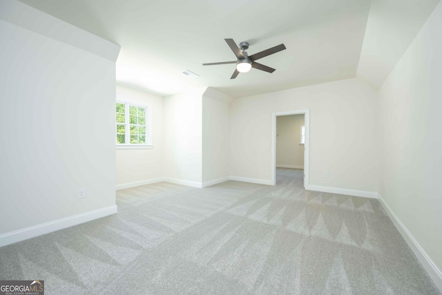 carpeted spare room with ceiling fan