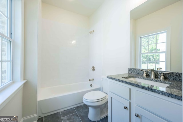 full bathroom with vanity, tile patterned flooring, tiled shower / bath, and toilet