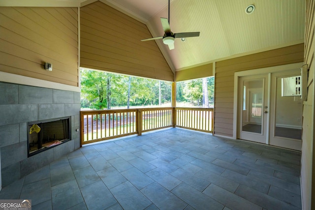 view of patio / terrace featuring ceiling fan and a tile fireplace