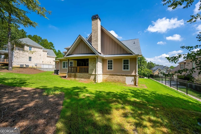 rear view of house featuring a lawn