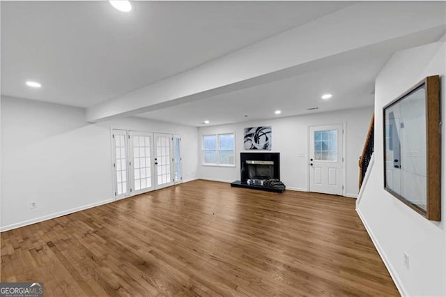 unfurnished living room with hardwood / wood-style flooring