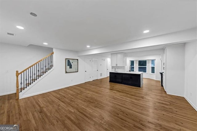 unfurnished living room with dark hardwood / wood-style floors