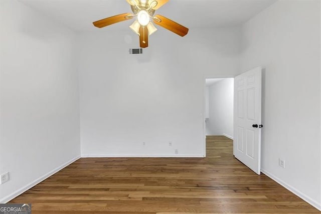 empty room featuring ceiling fan and hardwood / wood-style flooring