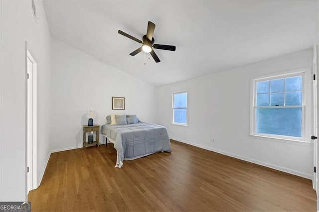 bedroom featuring vaulted ceiling, ceiling fan, and wood-type flooring