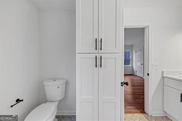 bathroom with toilet and vanity