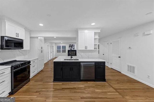 kitchen with stainless steel appliances, white cabinetry, and decorative backsplash