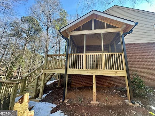 back of property featuring a wooden deck