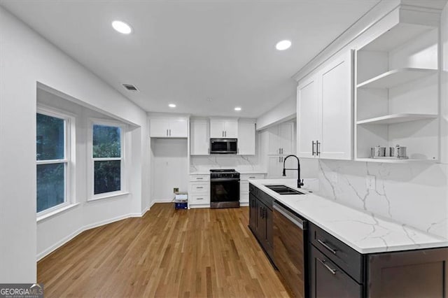 kitchen featuring sink, white cabinetry, stove, dark brown cabinets, and dishwashing machine