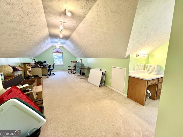 interior space with a textured ceiling, light colored carpet, and vaulted ceiling