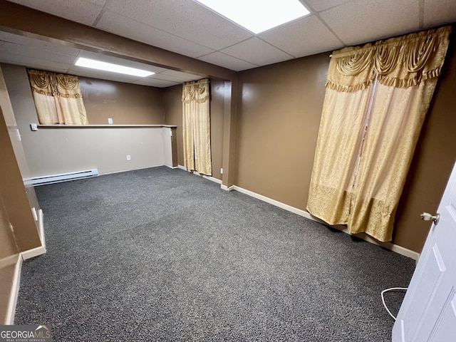 basement featuring carpet, a baseboard radiator, and a drop ceiling