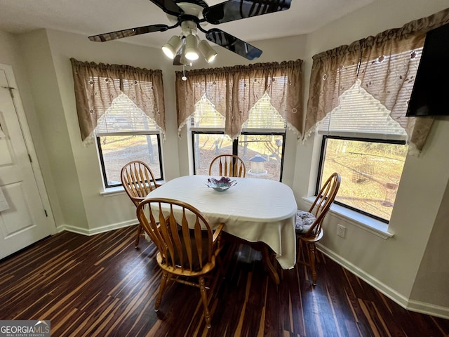 dining space with ceiling fan, plenty of natural light, and dark hardwood / wood-style floors