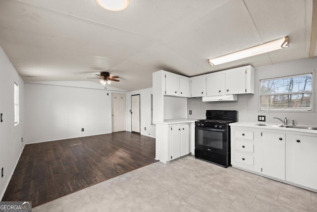 kitchen with lofted ceiling, white cabinets, light hardwood / wood-style flooring, ceiling fan, and black range with gas cooktop