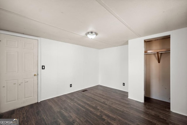 unfurnished bedroom with dark hardwood / wood-style flooring