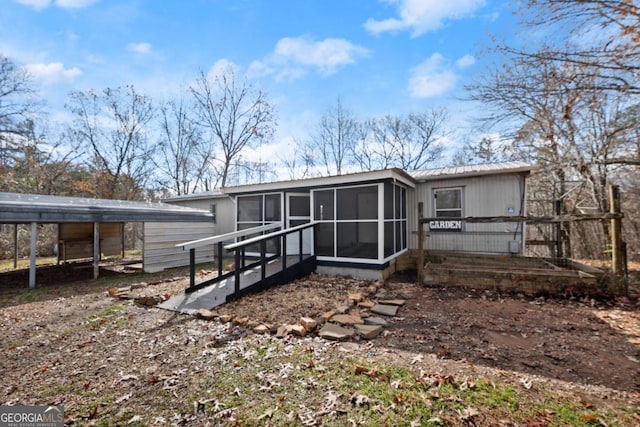 back of house featuring a carport and a sunroom